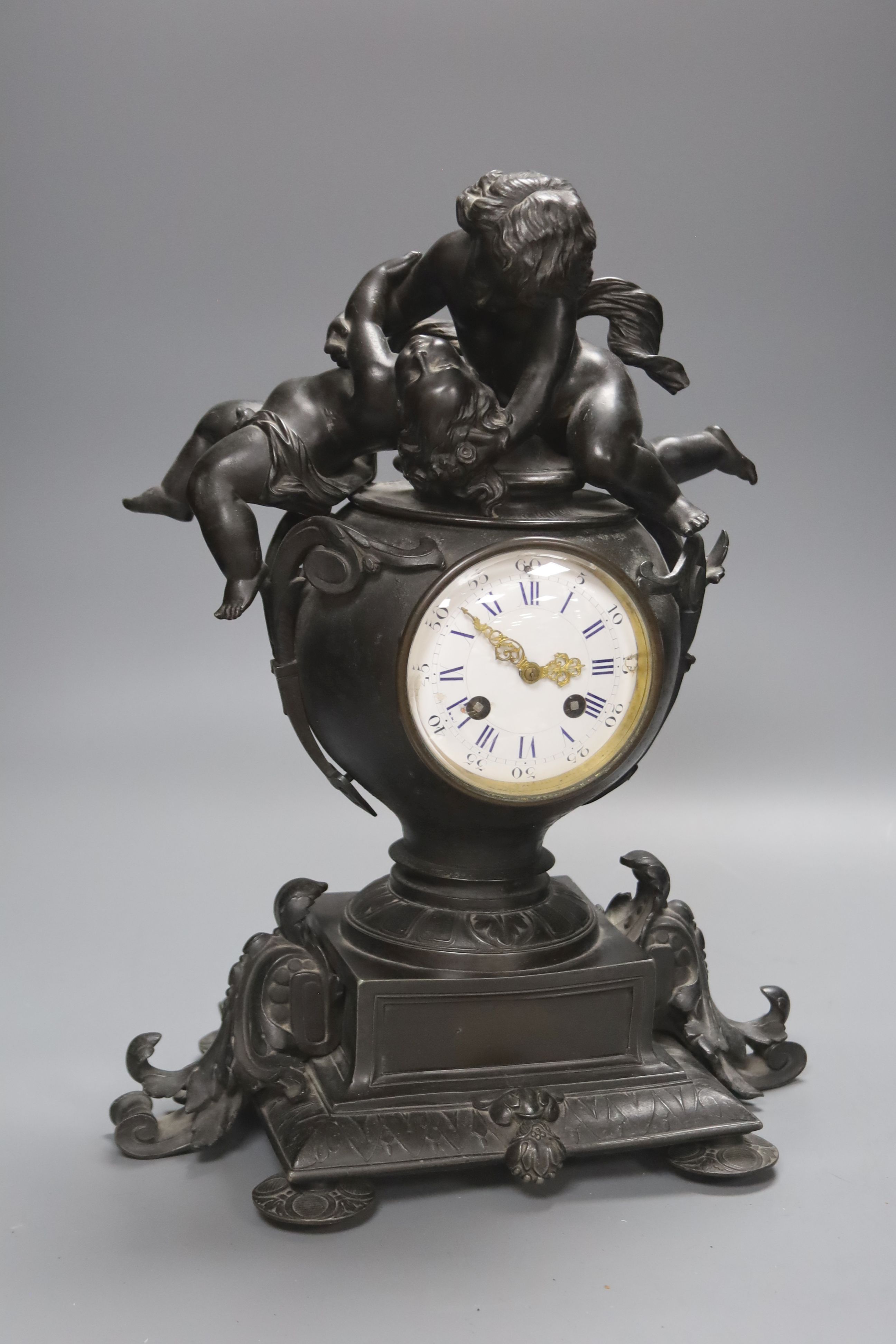 A Victorian spelter cherub mantel clock, height 39cm